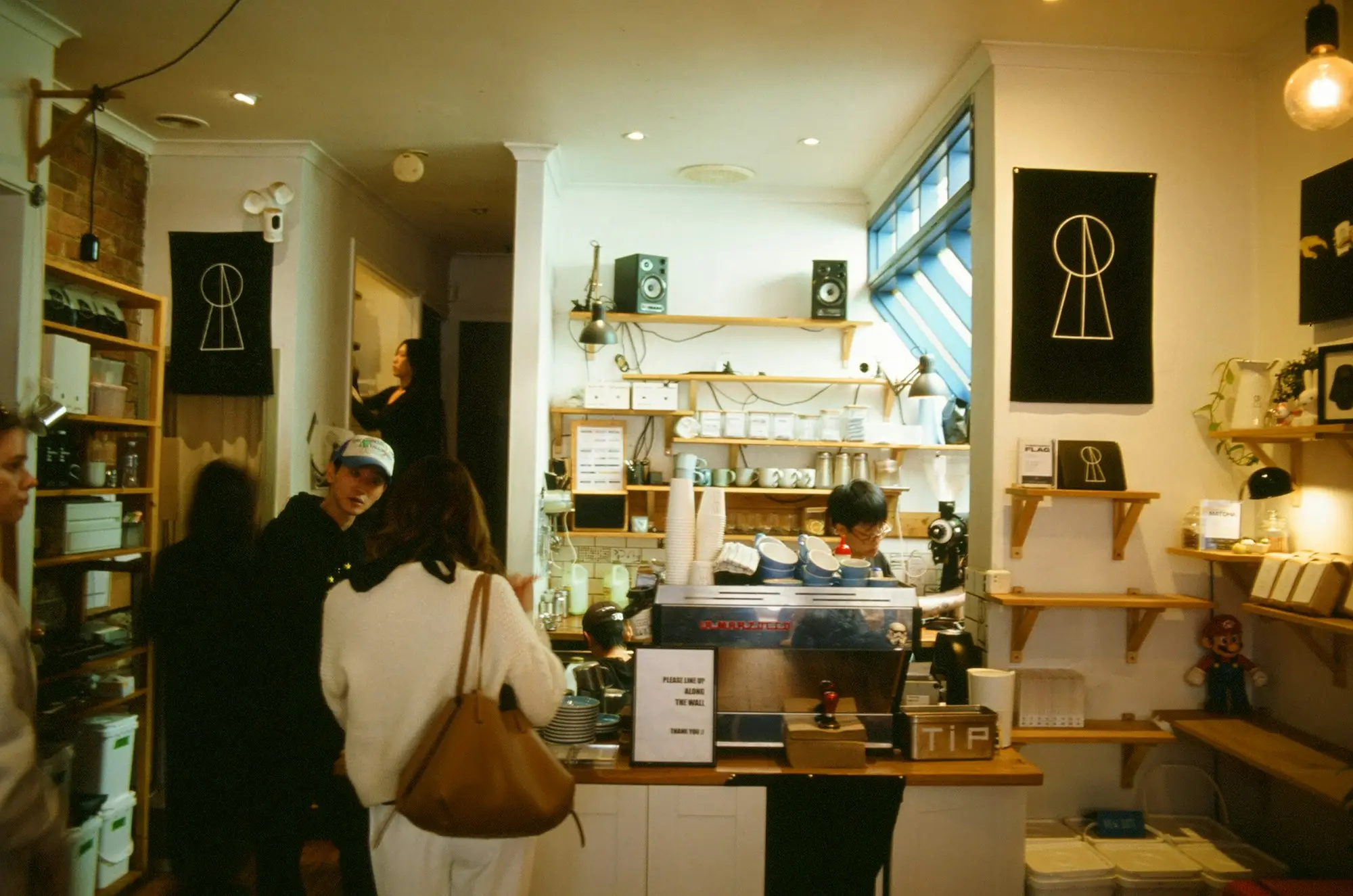 Cafe with a coffee machine and customers at the counter in Melbourne