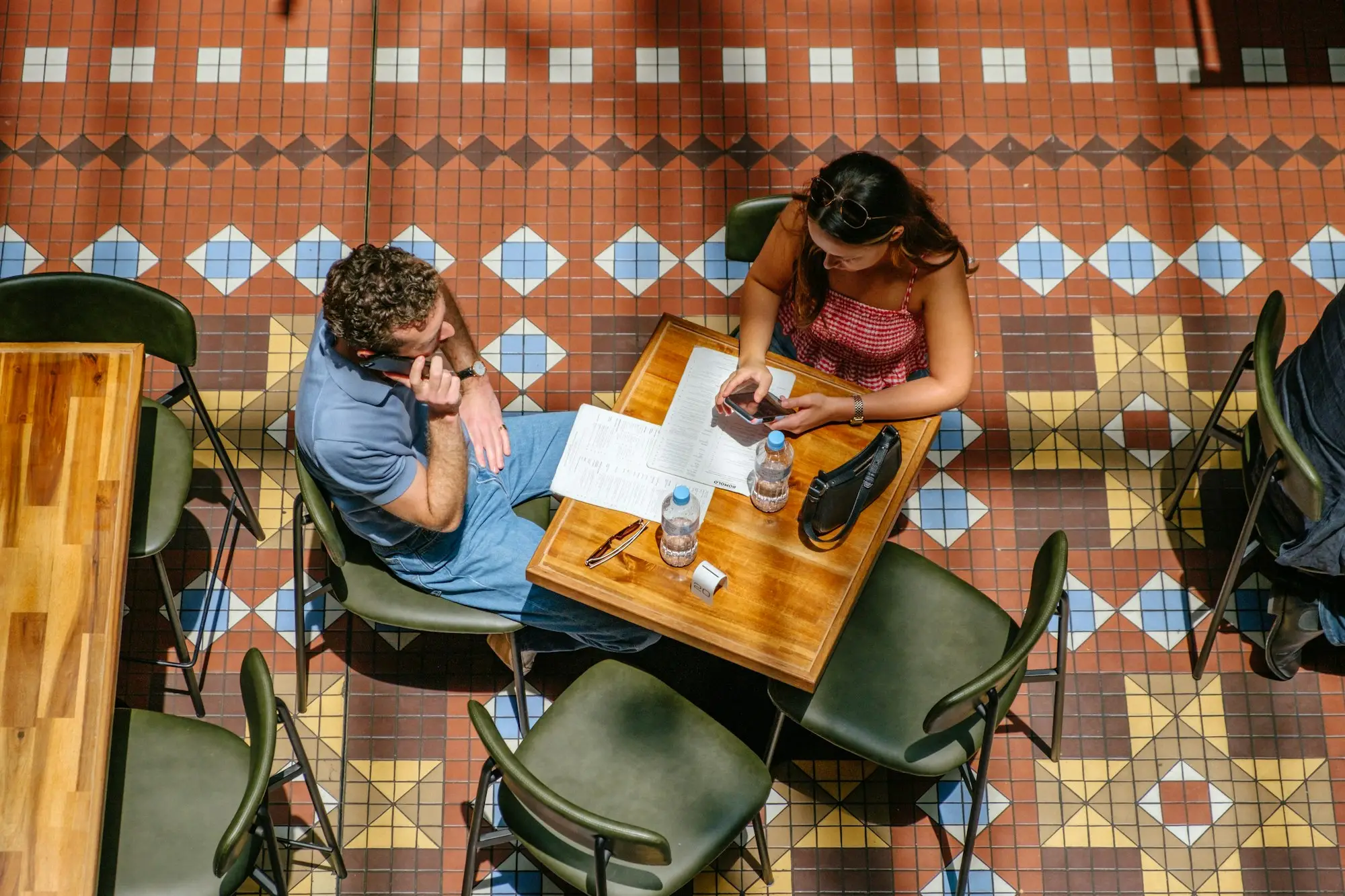 Sole trader working through company papers at a Sydney cafe
